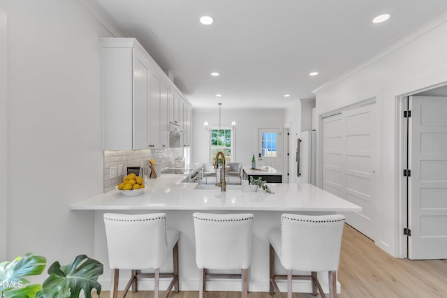 801 N Elm St, Durham, NC 27701 - kitchen with light countertops, a peninsula, white cabinetry, and a sink