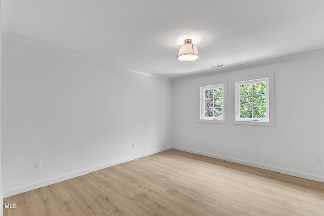 801 N Elm St, Durham, NC 27701 - spare room with baseboards, visible vents, and light wood-style flooring