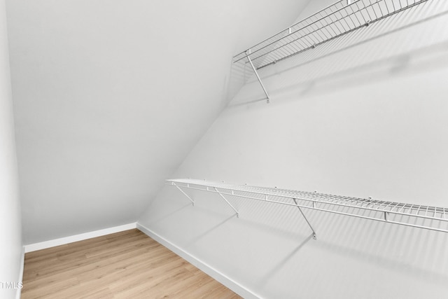 801 N Elm St, Durham, NC 27701 - walk in closet with vaulted ceiling and light wood-style floors