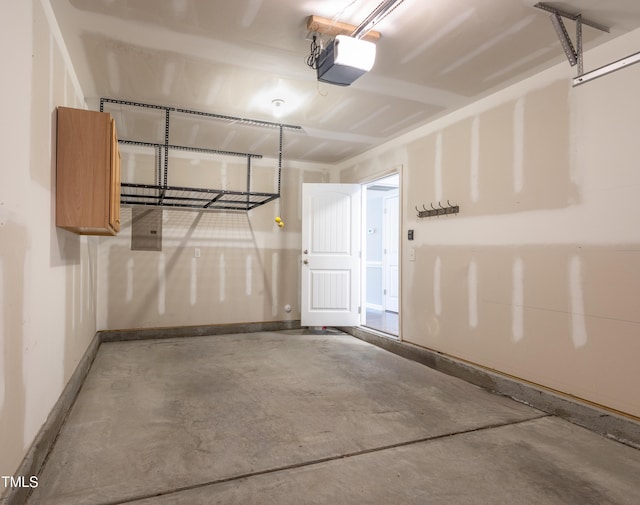 garage featuring baseboards and a garage door opener