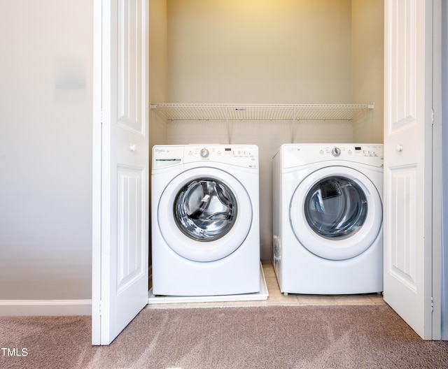 laundry area featuring carpet flooring, laundry area, and washer and clothes dryer