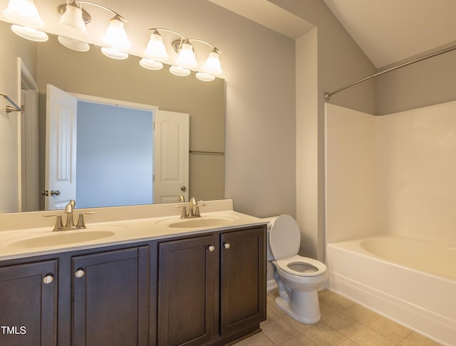 full bath featuring double vanity, a sink, tile patterned flooring, and toilet