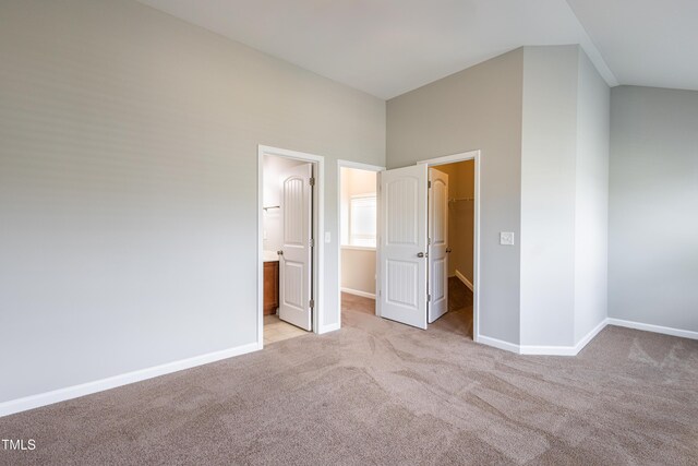 14 Prairie View Ct, Durham, NC 27703 - unfurnished bedroom with light colored carpet, a walk in closet, and baseboards