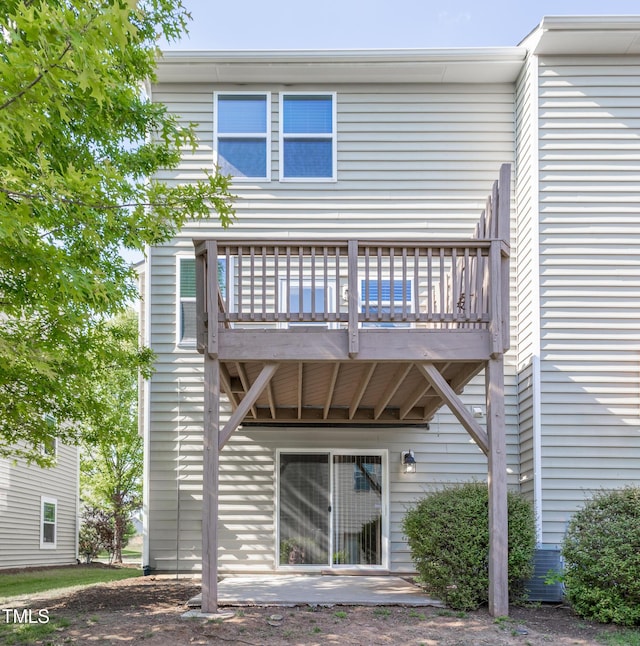 back of property featuring a wooden deck