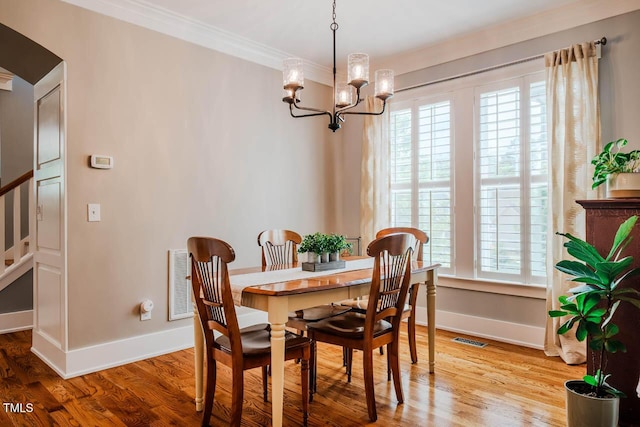 281 N Serenity Hill Cir, Chapel Hill, NC 27516 - dining space with a chandelier, baseboards, wood finished floors, and crown molding