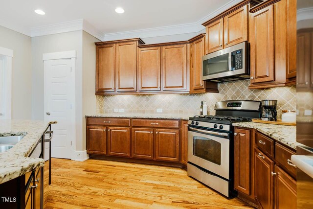 281 N Serenity Hill Cir, Chapel Hill, NC 27516 - kitchen featuring stainless steel appliances, light wood-style flooring, decorative backsplash, light stone counters, and ornamental molding