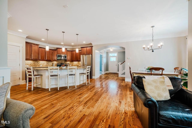 281 N Serenity Hill Cir, Chapel Hill, NC 27516 - kitchen featuring appliances with stainless steel finishes, open floor plan, arched walkways, a kitchen breakfast bar, and a chandelier