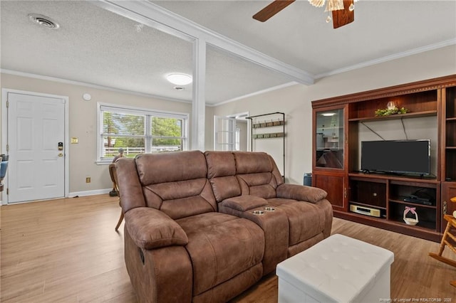living area with crown molding, ceiling fan, visible vents, and light wood finished floors