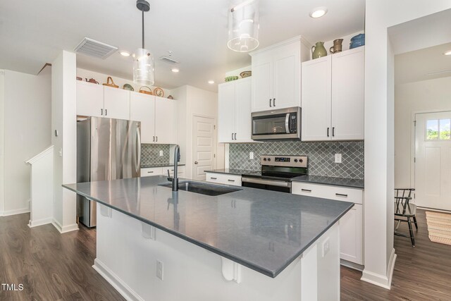 138 Rialto St, Chapel Hill, NC 27516 - kitchen featuring decorative backsplash, appliances with stainless steel finishes, a center island with sink, a sink, and dark wood-style floors