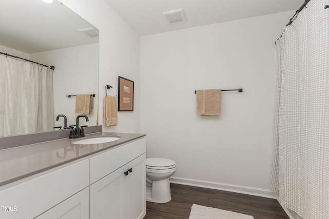 138 Rialto St, Chapel Hill, NC 27516 - full bathroom featuring visible vents, wood finished floors, vanity, baseboards, and toilet