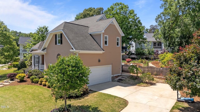 view of home's exterior featuring fence, a shingled roof, a garage, a yard, and driveway