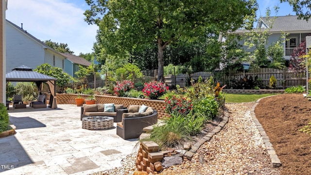 view of patio / terrace with fence, a gazebo, and an outdoor living space
