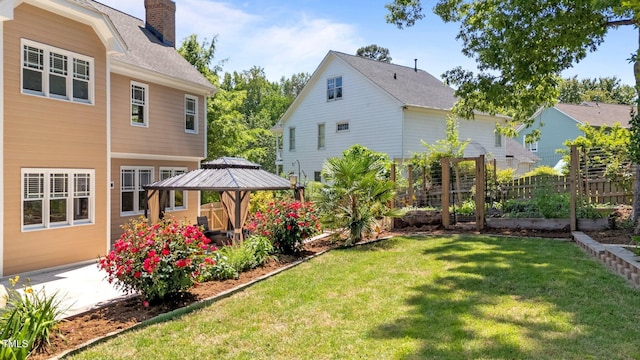 view of yard with fence, a gazebo, and a patio area