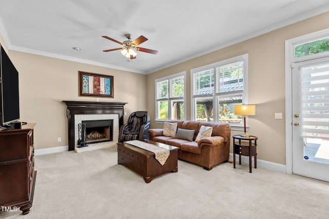 living area featuring ornamental molding, a ceiling fan, a wealth of natural light, and light carpet