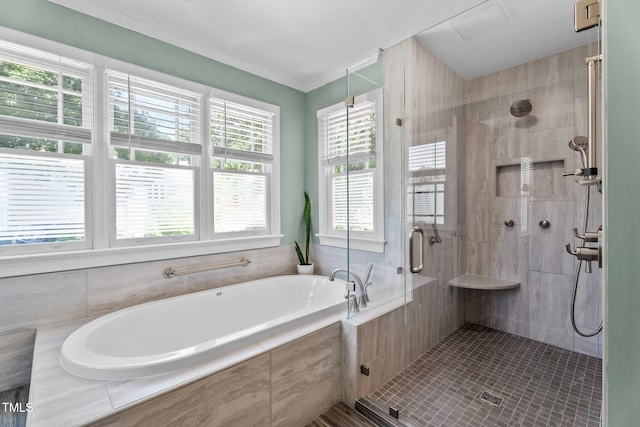 bathroom featuring ornamental molding, a garden tub, and a stall shower