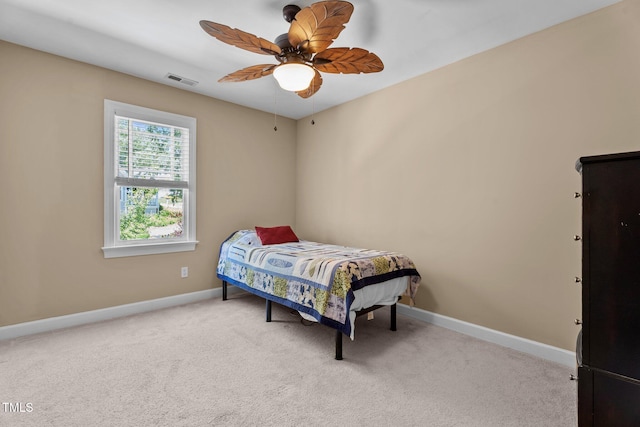 carpeted bedroom with baseboards, visible vents, and ceiling fan