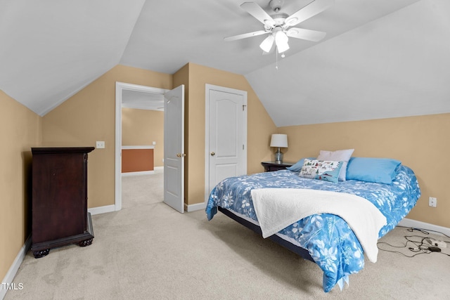 bedroom featuring baseboards, light carpet, ceiling fan, and lofted ceiling