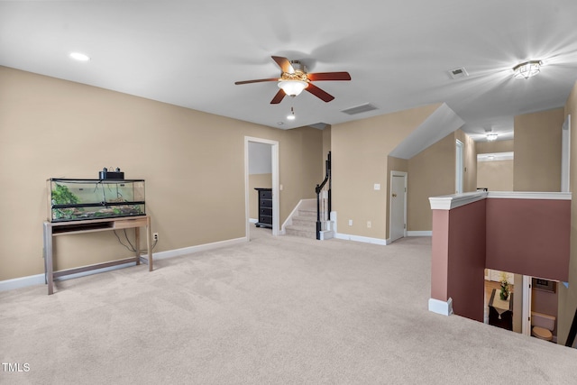 interior space with baseboards, light carpet, a ceiling fan, and visible vents