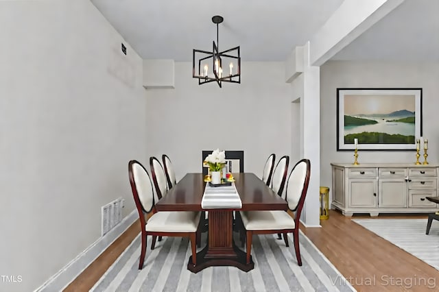 1304 Seaton Rd Unit 24, Durham, NC 27713 - dining space with a chandelier and light wood-style floors