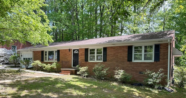 1713 S Garnett St, Henderson, NC 27536 - view of front of house with a garage, brick siding, and driveway