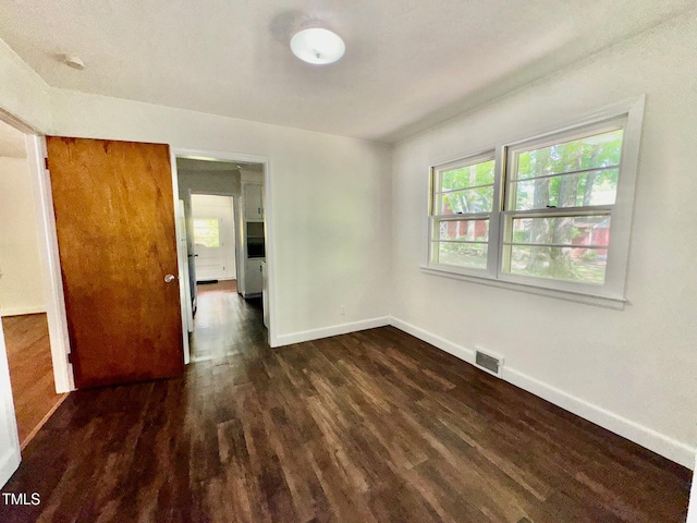 1713 S Garnett St, Henderson, NC 27536 - empty room featuring baseboards and dark wood-style flooring