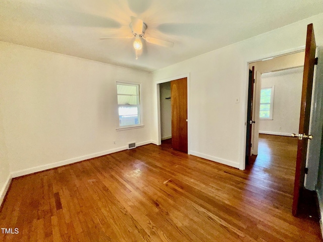 1713 S Garnett St, Henderson, NC 27536 - unfurnished bedroom with wood finished floors, baseboards, a closet, and a ceiling fan
