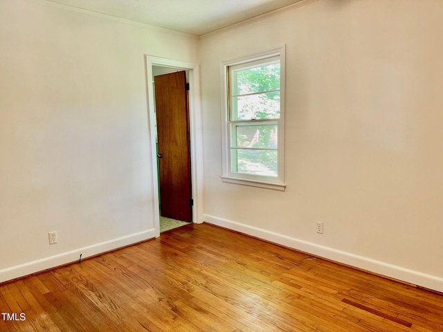 1713 S Garnett St, Henderson, NC 27536 - spare room featuring crown molding, baseboards, and light wood-style flooring