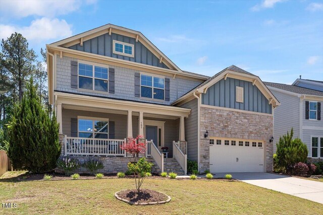 105 Blue Prince Trl, Holly Springs, NC 27540 - craftsman inspired home with board and batten siding, stone siding, concrete driveway, a front yard, and covered porch