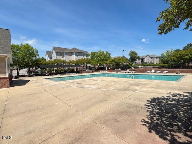 community pool with a patio area