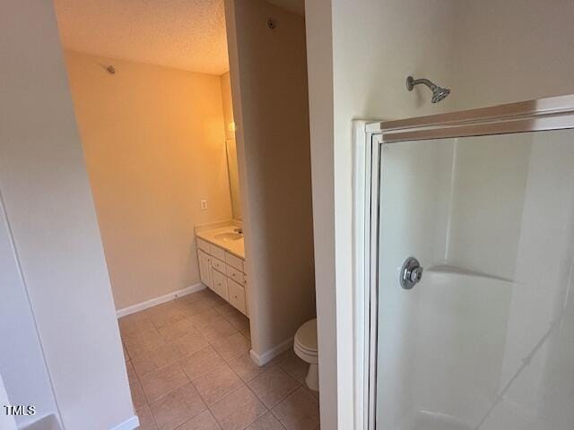 full bath featuring baseboards, tile patterned flooring, a stall shower, and toilet