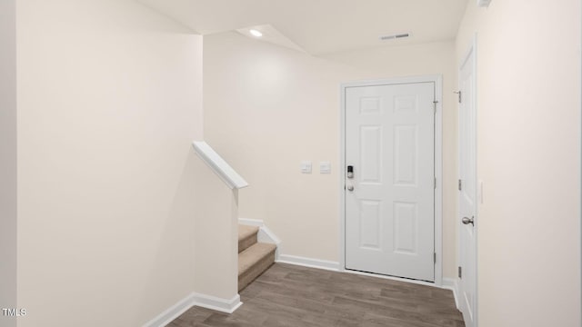 interior space featuring visible vents, wood finished floors, baseboards, stairway, and recessed lighting