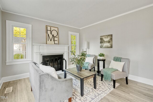 226 S Windsor Dr, Fayetteville, NC 28301 - living area with crown molding, visible vents, a wealth of natural light, and wood finished floors