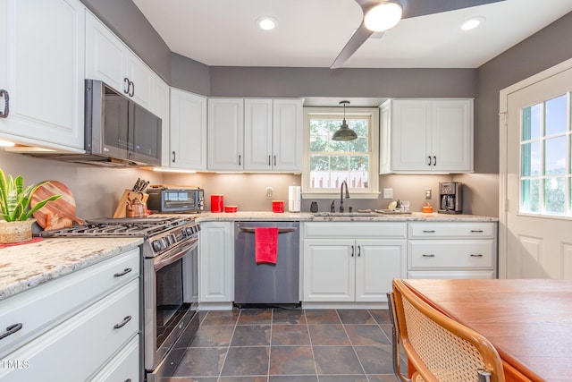 kitchen featuring a sink, white cabinets, stainless steel appliances, and a healthy amount of sunlight