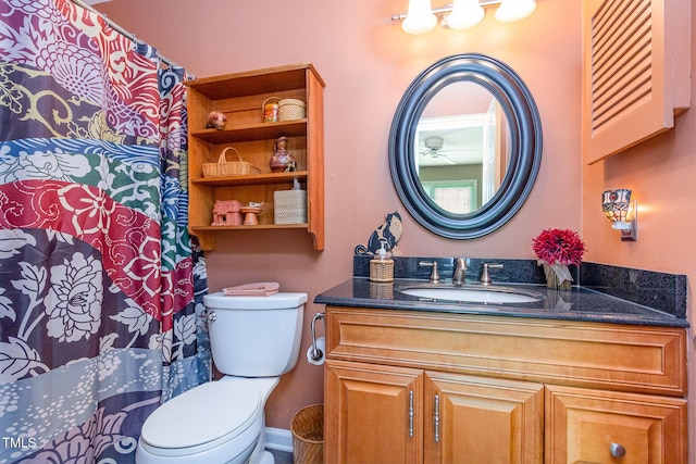 bathroom featuring vanity, baseboards, toilet, and a shower with curtain