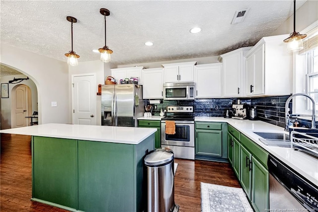 kitchen featuring white cabinetry, a textured ceiling, appliances with stainless steel finishes, and green cabinets