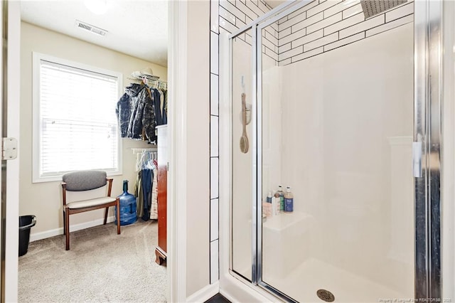 full bathroom featuring visible vents, baseboards, a stall shower, and a spacious closet