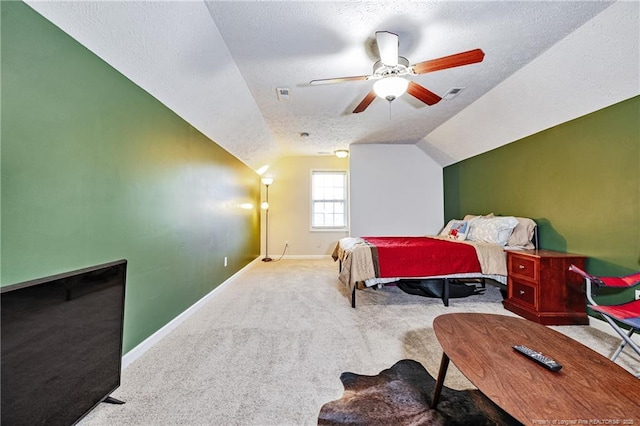 carpeted bedroom with visible vents, lofted ceiling, baseboards, a textured ceiling, and a ceiling fan