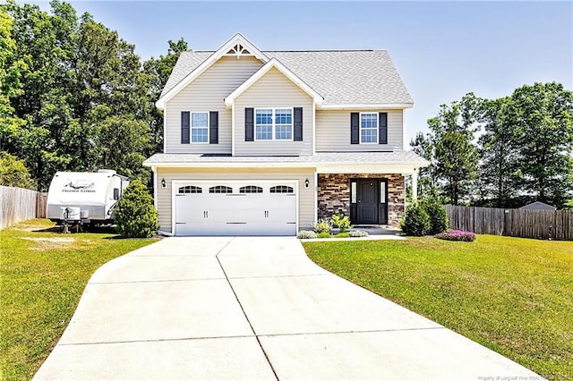 view of front of house featuring fence, a front yard, and concrete driveway