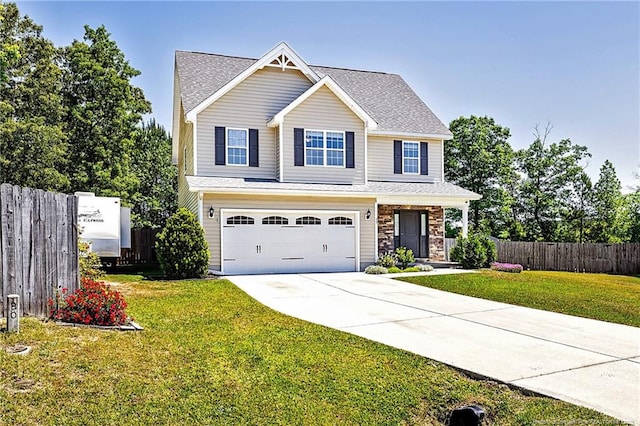 view of front of property featuring fence, an attached garage, driveway, and a front lawn