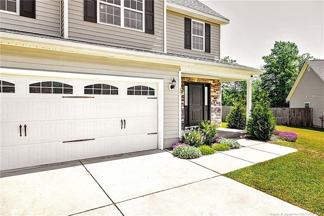 exterior space with fence, covered porch, and concrete driveway