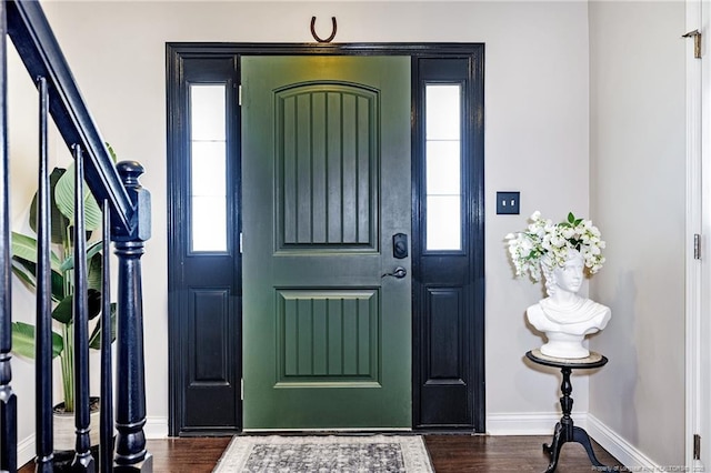 foyer with dark wood-type flooring, baseboards, and a healthy amount of sunlight