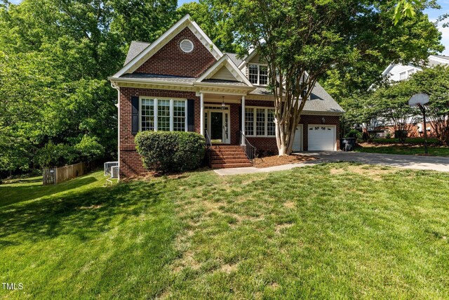 craftsman inspired home with brick siding, a garage, a front yard, and aphalt driveway