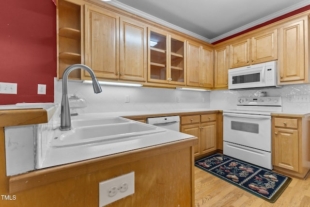 kitchen with decorative backsplash, light wood-type flooring, a sink, glass insert cabinets, and white appliances