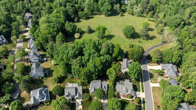 drone / aerial view with a wooded view and a residential view