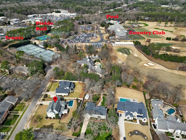 view of property location with a local golf course and nearby suburban area