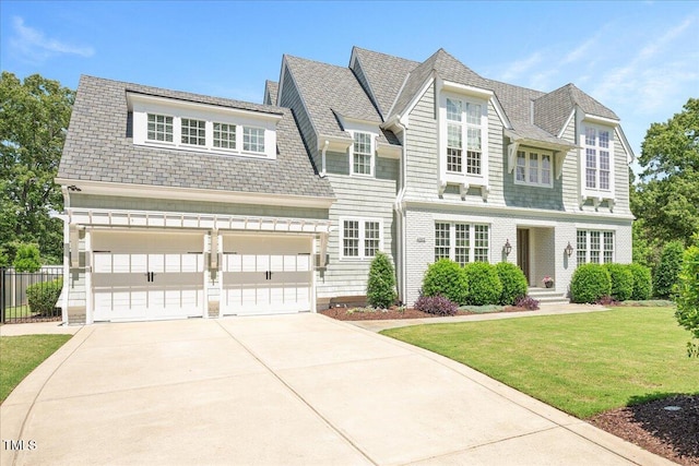shingle-style home with driveway and an attached garage
