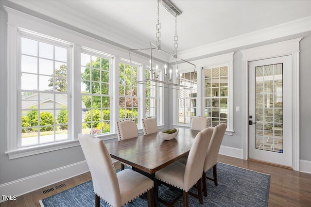 sunroom / solarium with a chandelier