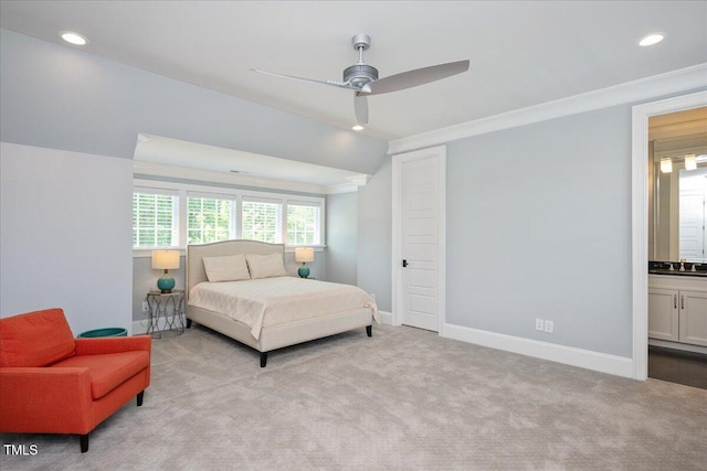 carpeted bedroom with crown molding, a sink, recessed lighting, baseboards, and ensuite bathroom