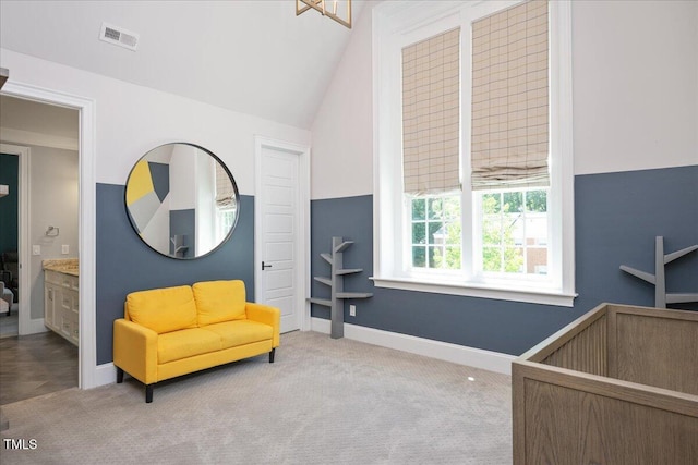 bedroom with carpet floors, lofted ceiling, and baseboards