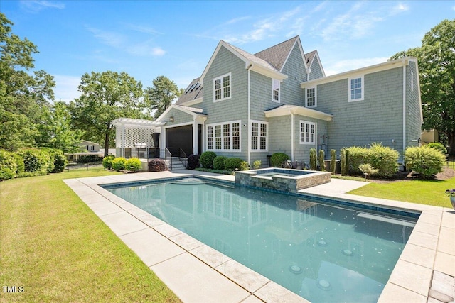 back of property featuring a yard, a pergola, a pool with connected hot tub, and an attached garage